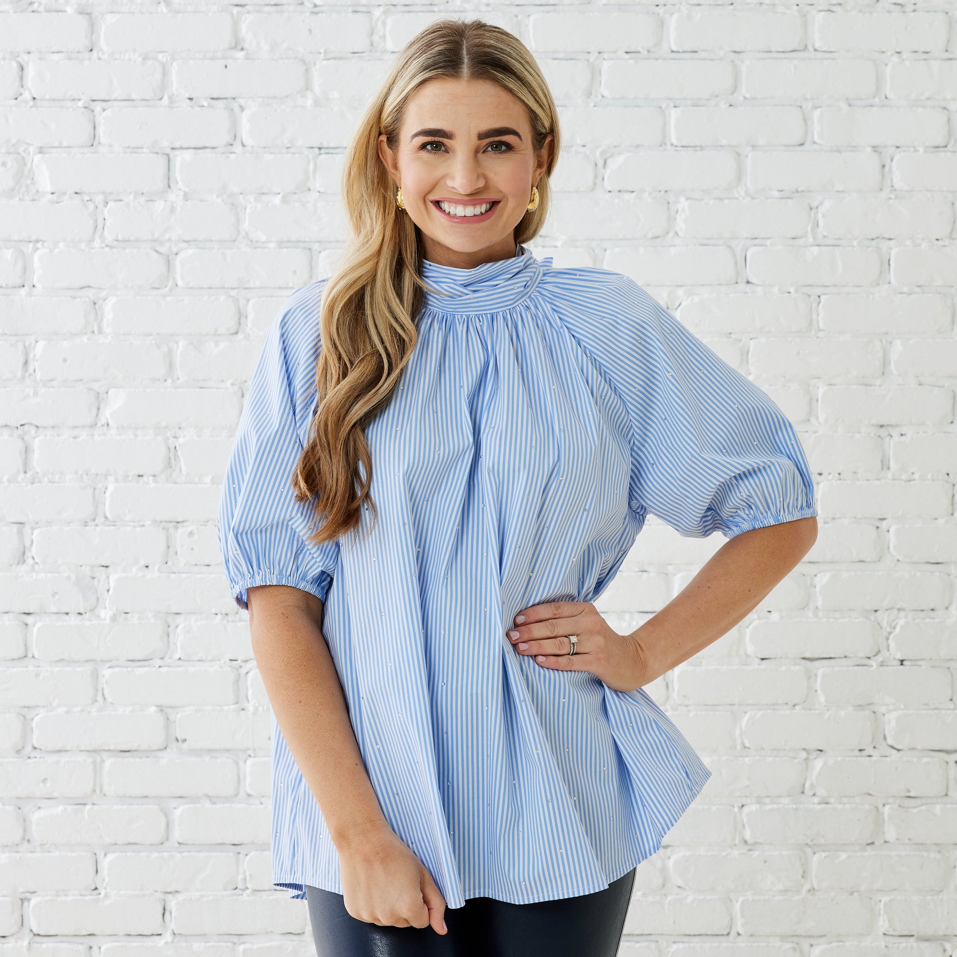 Caryn Lawn Ryan Bow Top in blue and white stripe with puff sleeves on smiling model